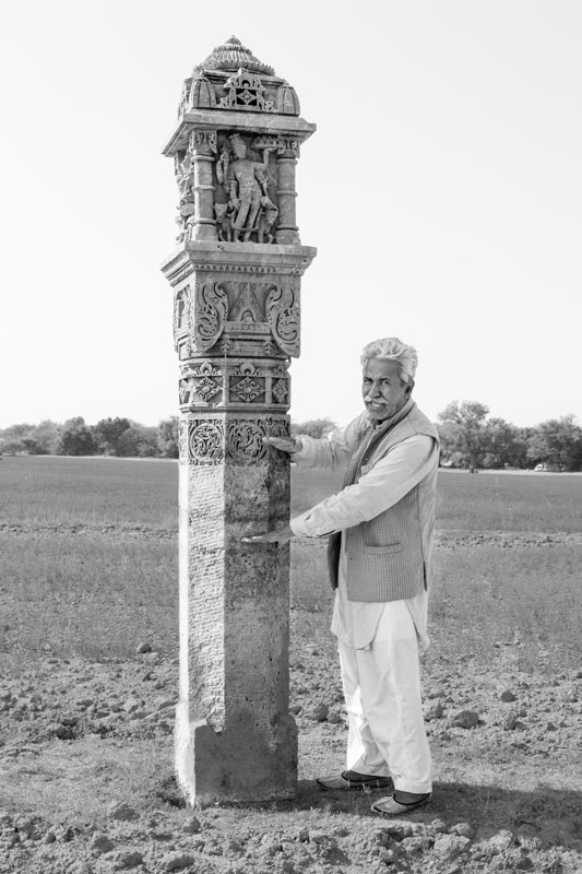 Chattar Singh Jam, the Water Wizard of Thar Desert, explaining about 'Goedhan' (a pillar used for measuring water level during inundation) in Derasar 'khadin' in Jaisalmer district, Rajasthan